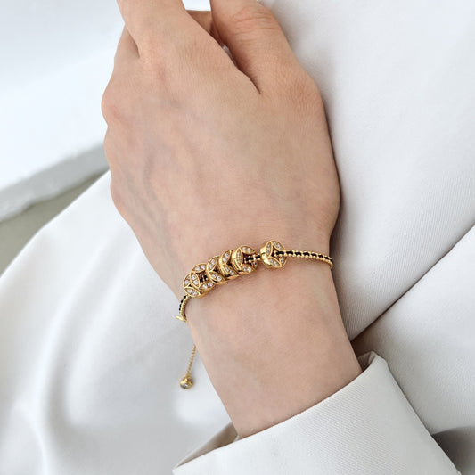 Noir Luxe Coin Charm Bracelet – 925 Sterling Silver with Black-Gold Braided Design.