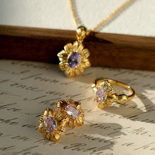 Gold jewelry set with purple gemstones on an old letter, branded 'SW accessories'.