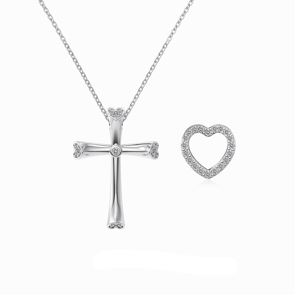 Silver cross and heart-shaped pendants on a chain with 'Dike Jewelry' branding.