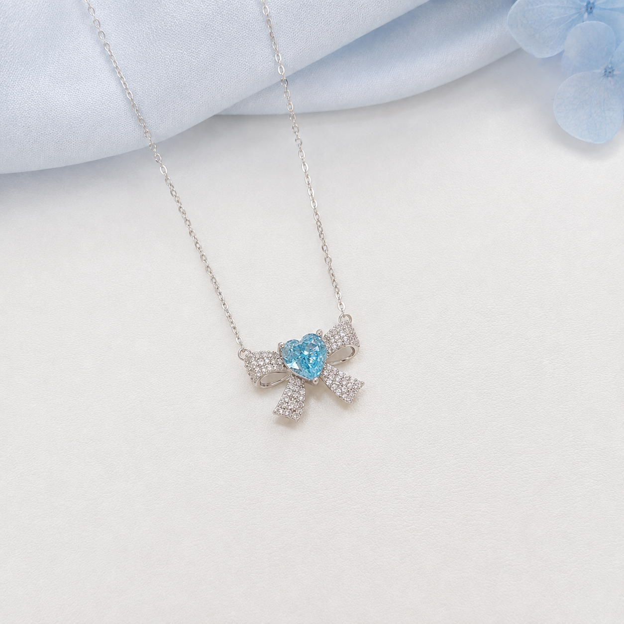 “Blue Bow Éclat” S925 Sterling Silver Ice-Cut Blue Heart Bow Necklace