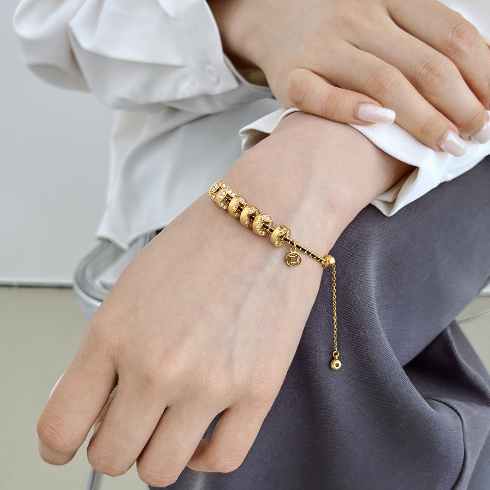 Noir Luxe Coin Charm Bracelet – 925 Sterling Silver with Black-Gold Braided Design.