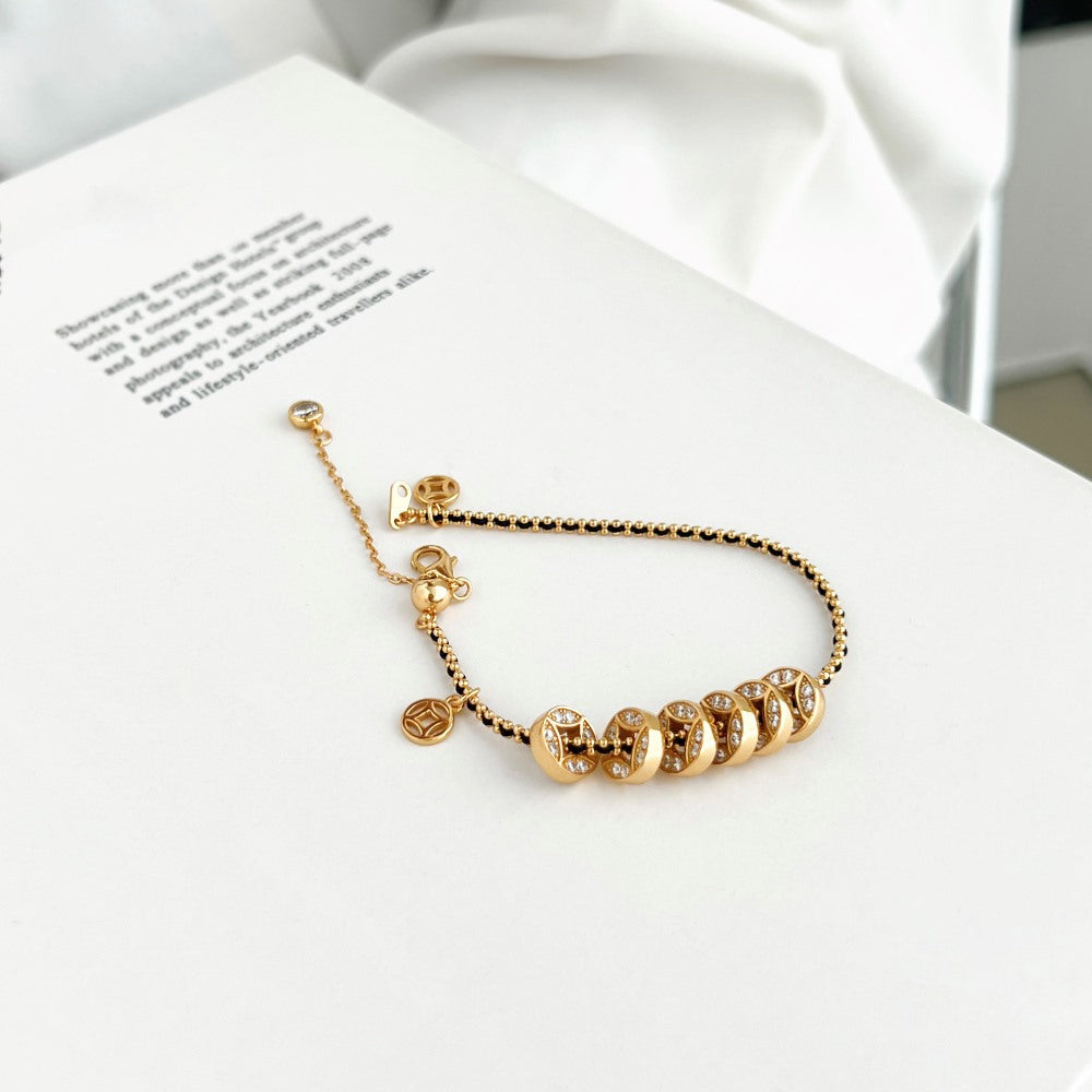 Noir Luxe Coin Charm Bracelet – 925 Sterling Silver with Black-Gold Braided Design.