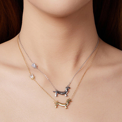Necklace with dog pendants on a model against a dark background