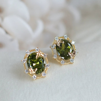 Green gemstone earrings with gold accents on a white background, branded 'SW accessories'.