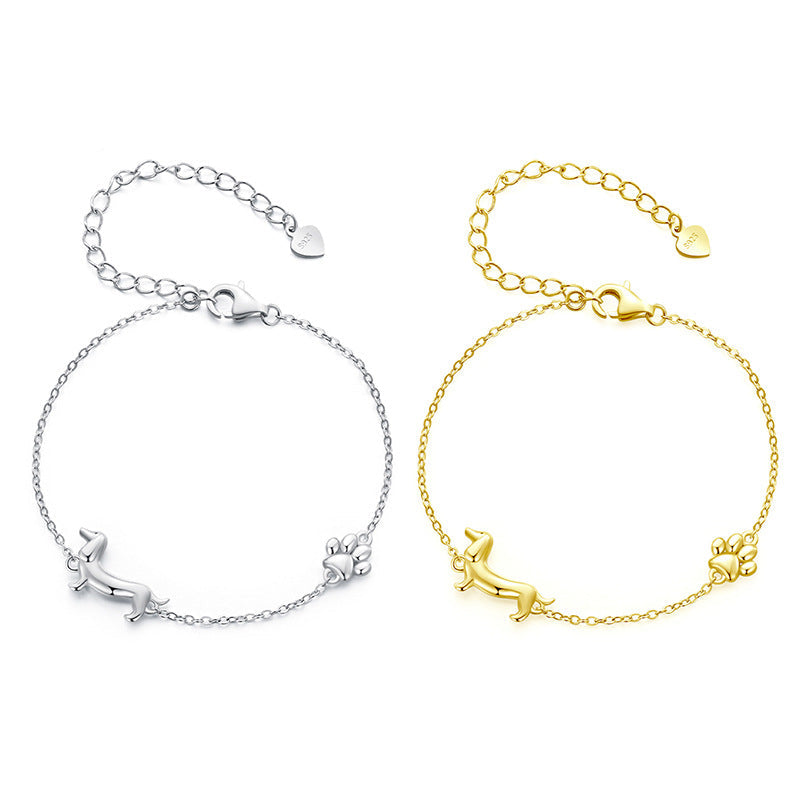 Two silver and gold bracelets with a brand logo on a white background
