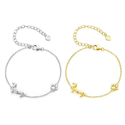 Two silver and gold bracelets with a brand logo on a white background