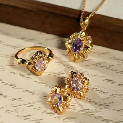 Gold jewelry set with pink gemstones on a piece of paper, branded 'SW accessories'.