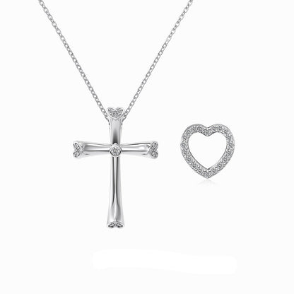 Silver cross and heart-shaped pendants on a chain with 'Dike Jewelry' branding.